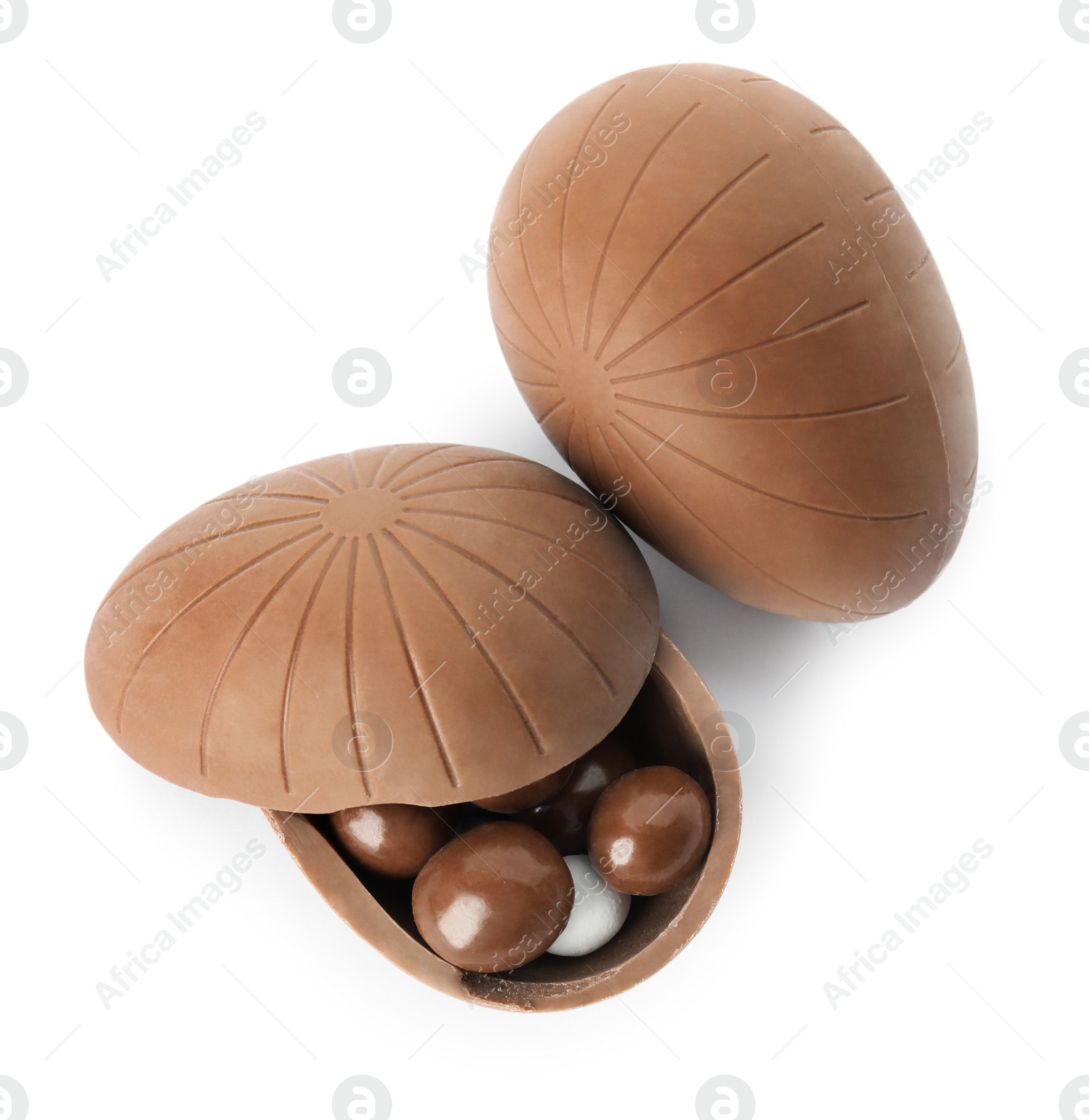 Photo of Tasty chocolate eggs with candies on white background, top view