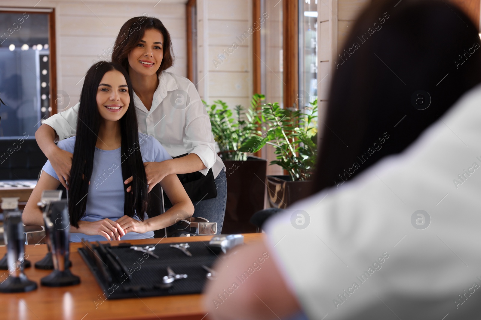 Photo of Hairdresser working with client in beauty salon