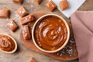 Photo of Salted caramel on wooden table, flat lay
