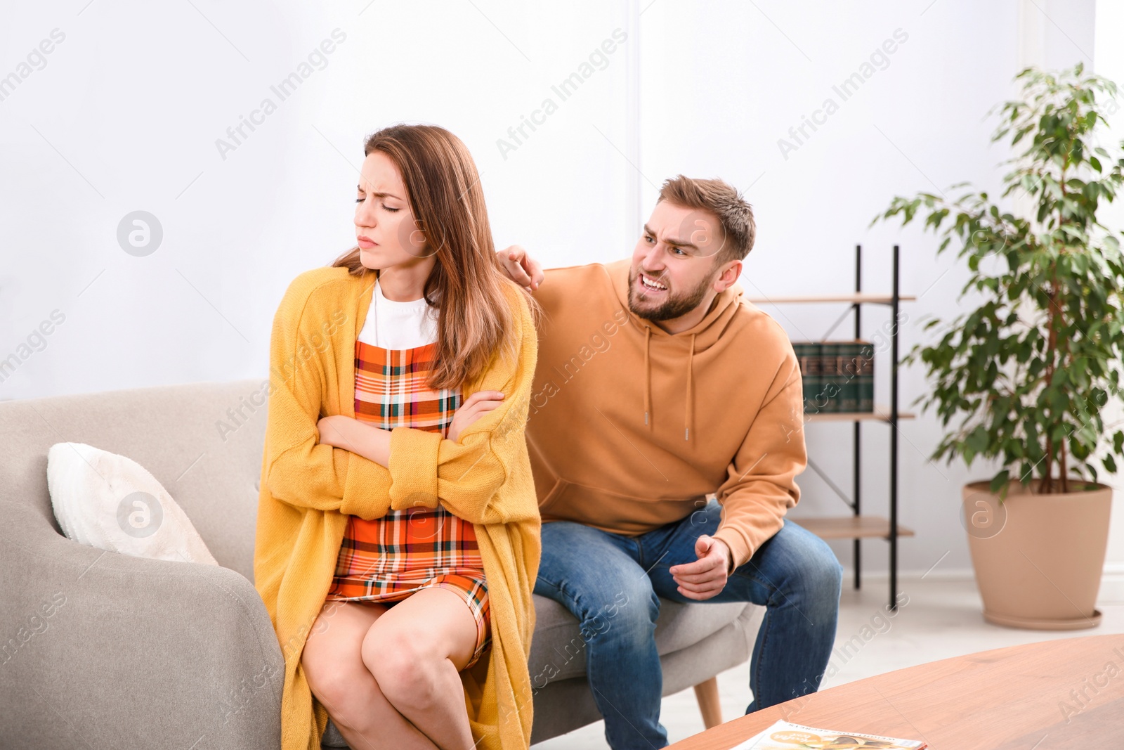 Photo of Couple having quarrel at home. Relationship problems