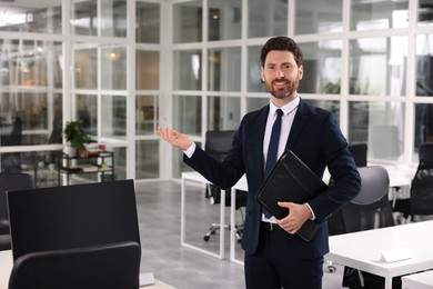 Happy real estate agent with leather portfolio in office