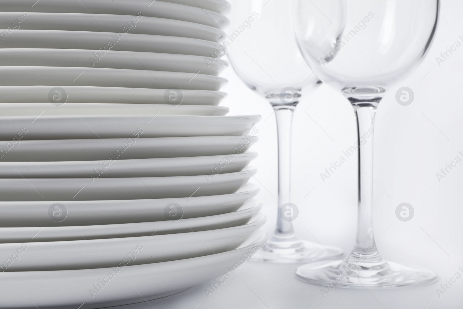 Photo of Set of clean tableware on white background, closeup. Washing dishes