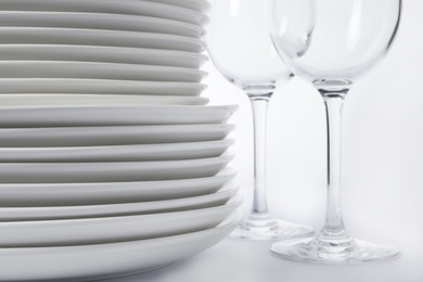 Set of clean tableware on white background, closeup. Washing dishes