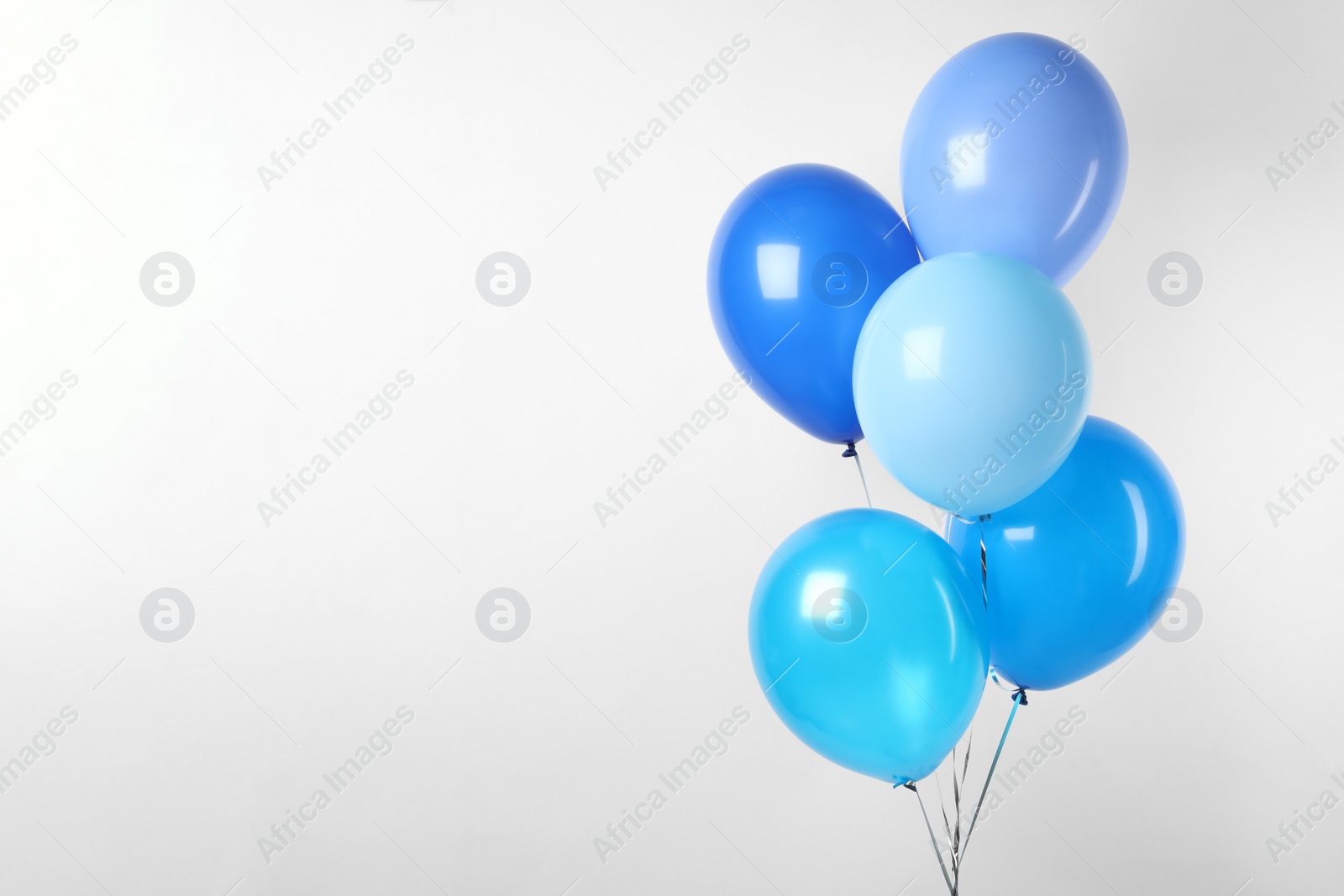 Photo of Bunch of blue balloons on white background. Greeting card