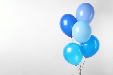 Photo of Bunch of blue balloons on white background. Greeting card