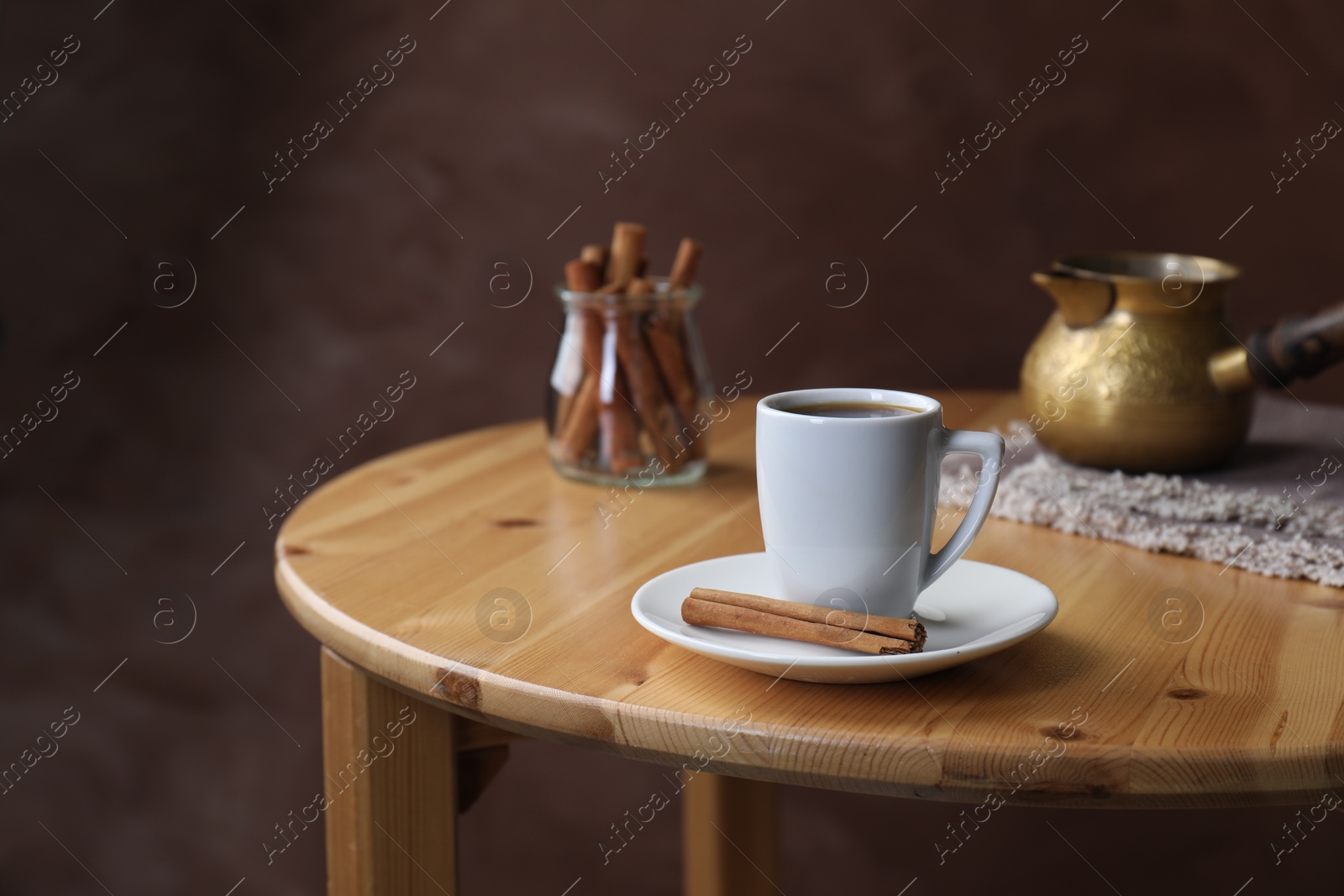 Photo of Turkish coffee. Freshly brewed beverage on wooden table