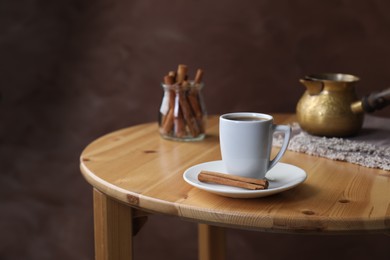 Photo of Turkish coffee. Freshly brewed beverage on wooden table