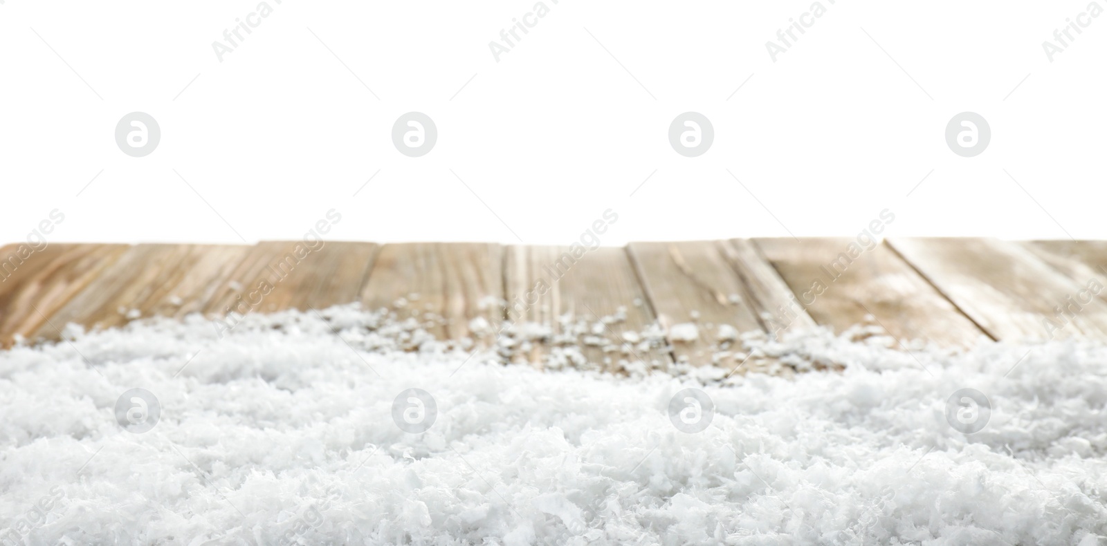 Photo of Heap of snow on wooden table against white background. Christmas season