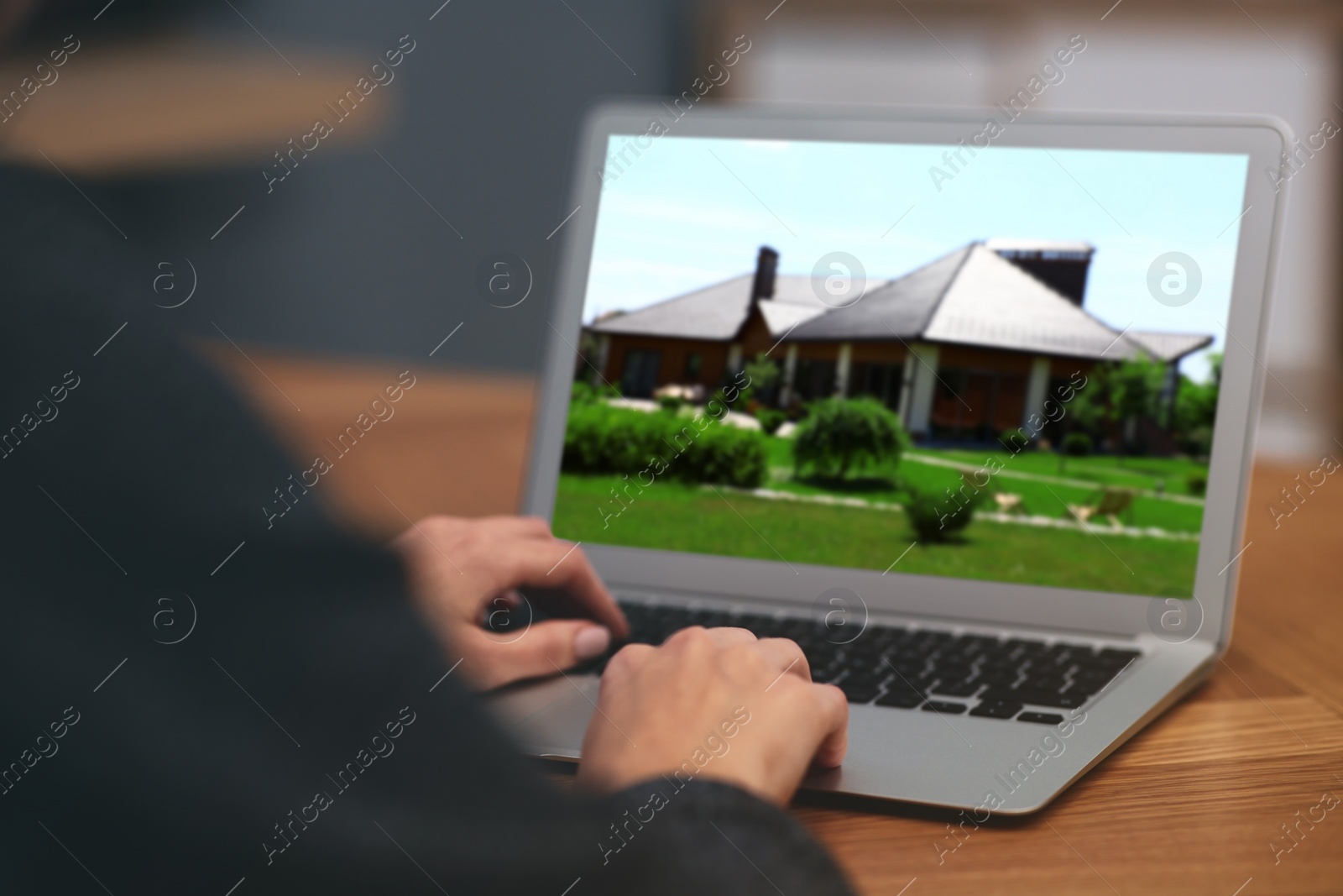 Image of Woman choosing new house online using laptop or real estate agent working at table, closeup