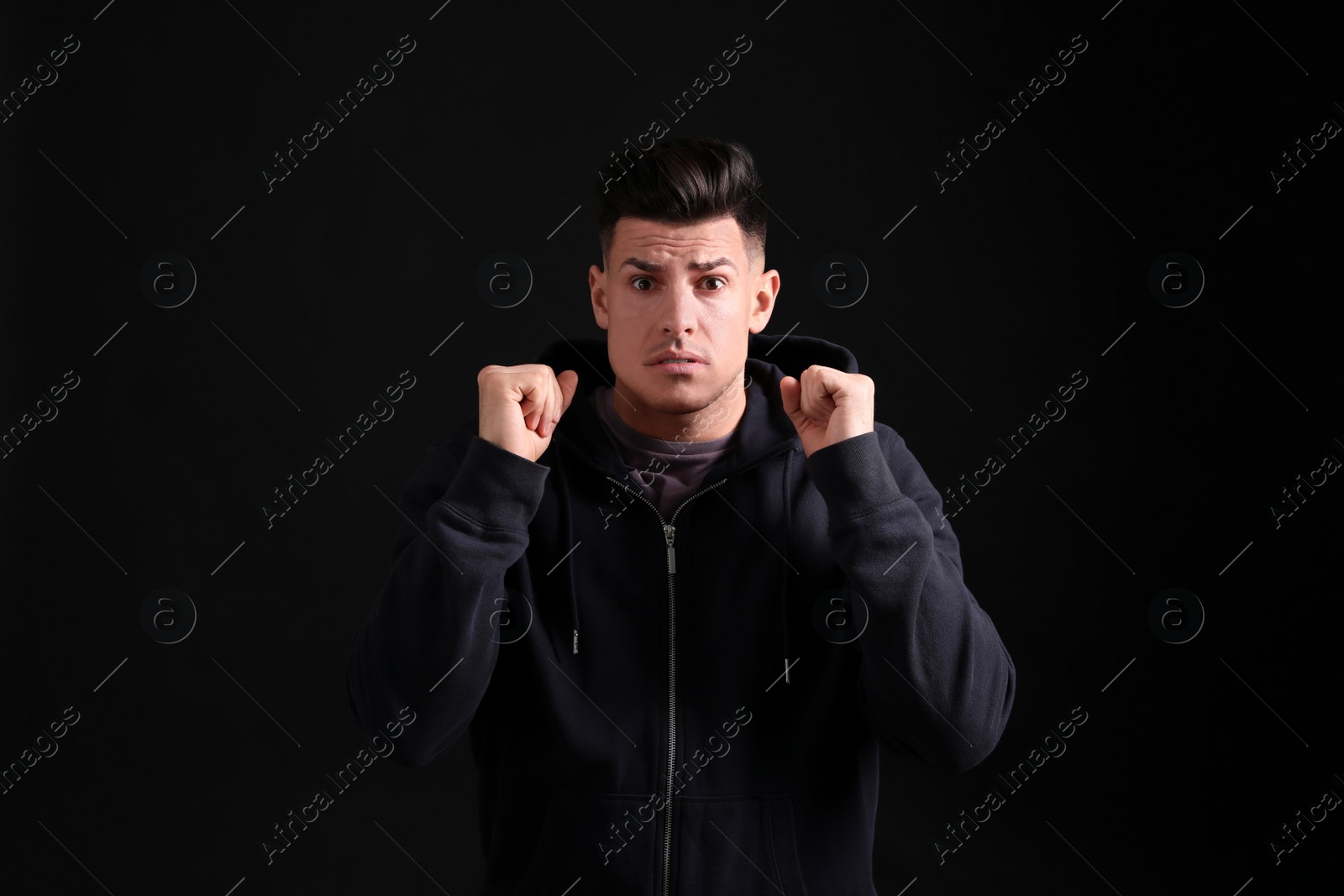 Photo of Portrait of emotional man on black background. Personality concept