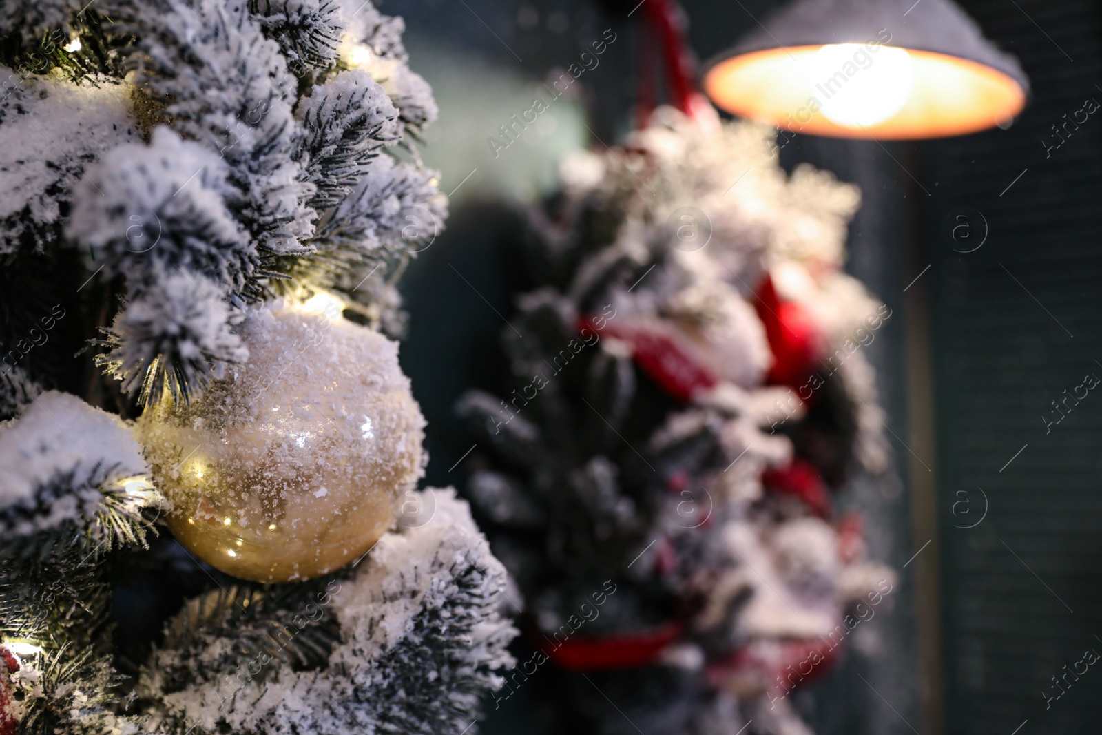 Photo of Beautiful decorative garland covered with snow outdoors, closeup. Christmas celebration