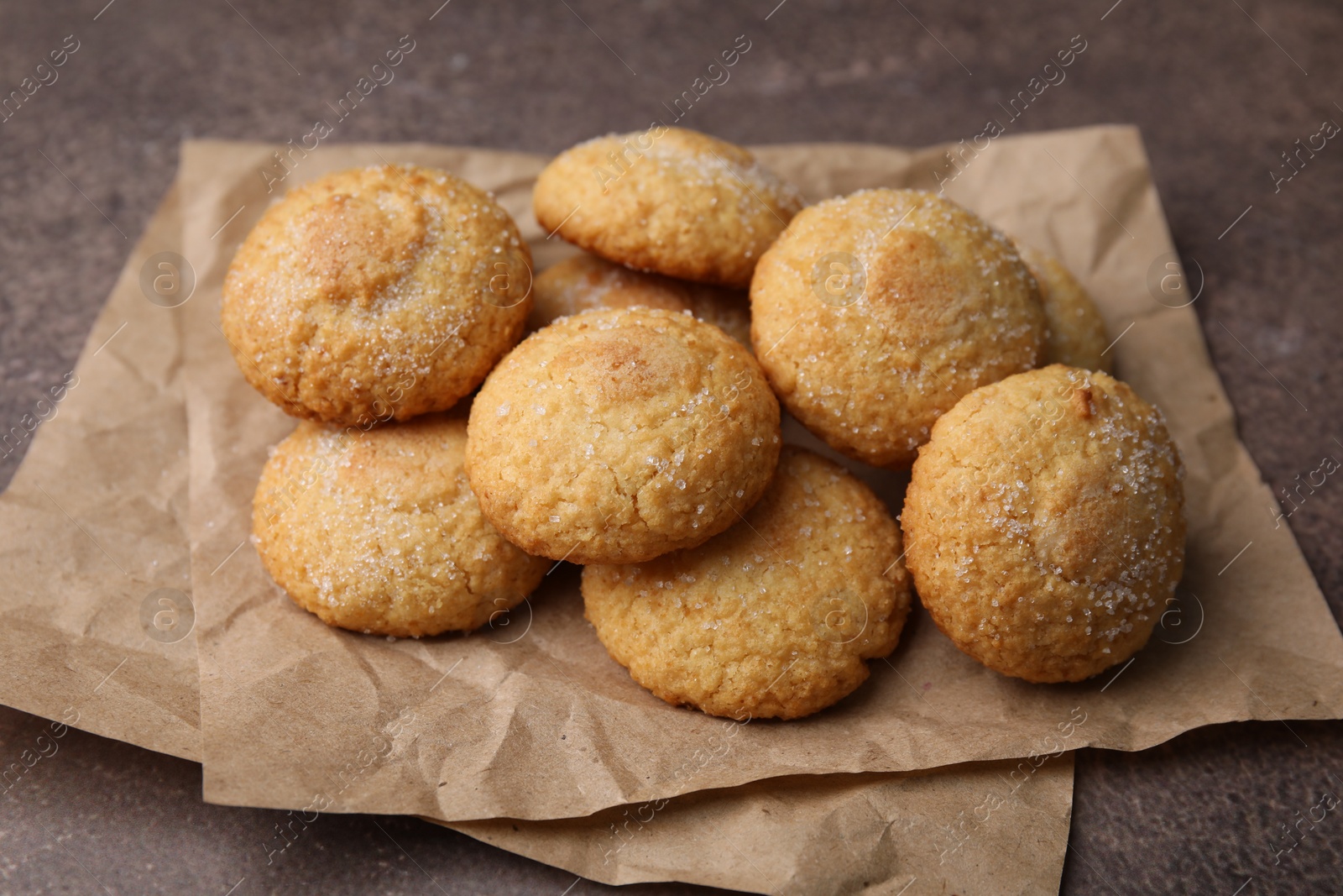 Photo of Tasty sweet sugar cookies on brown table, closeup