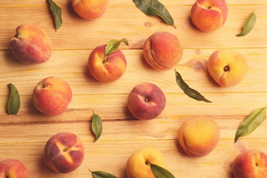 Photo of Fresh sweet peaches on wooden table, flat lay