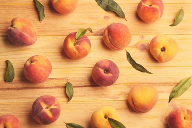 Fresh sweet peaches on wooden table, flat lay