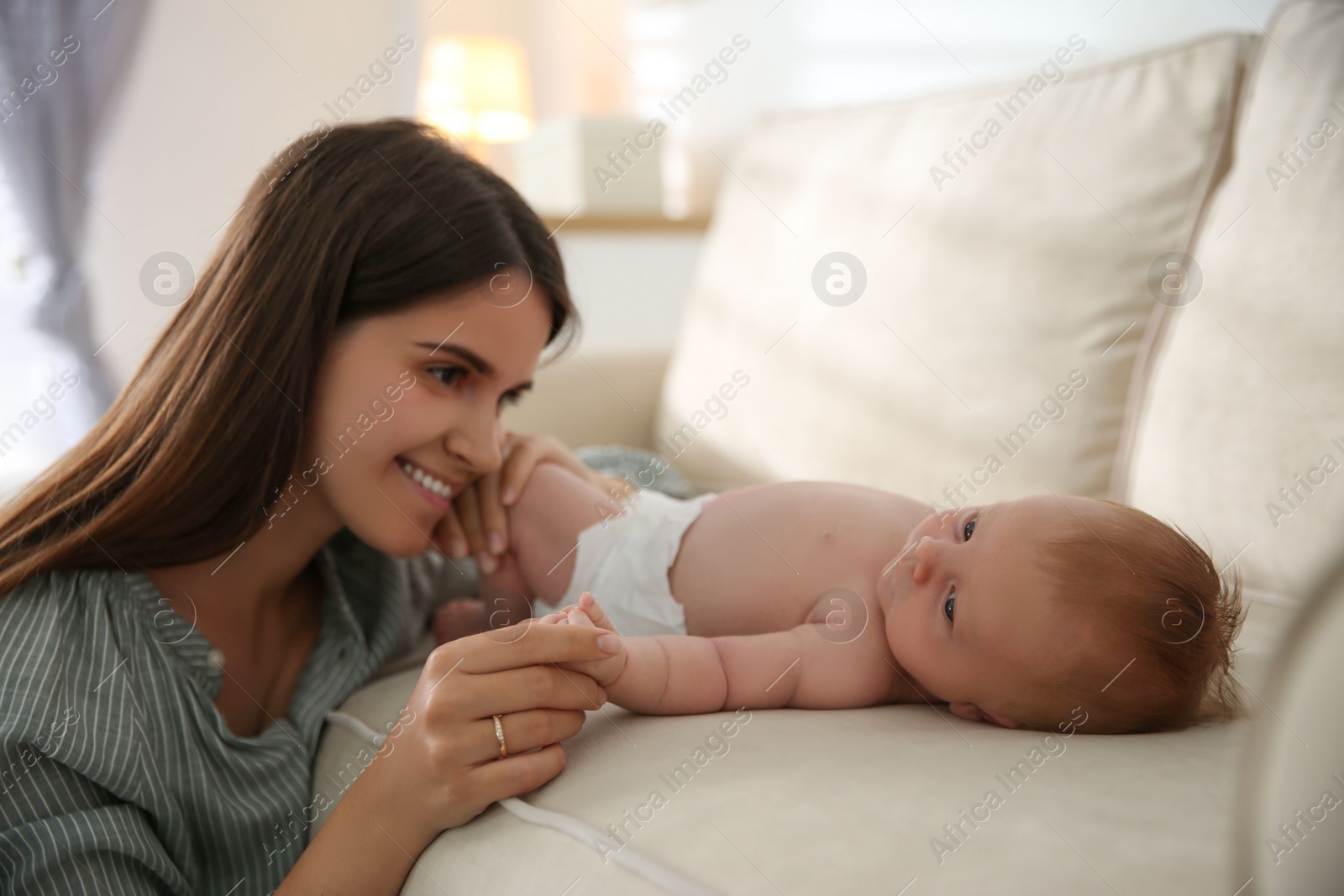 Photo of Mother with her newborn baby at home