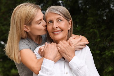 Photo of Happy mature mother and her daughter outdoors