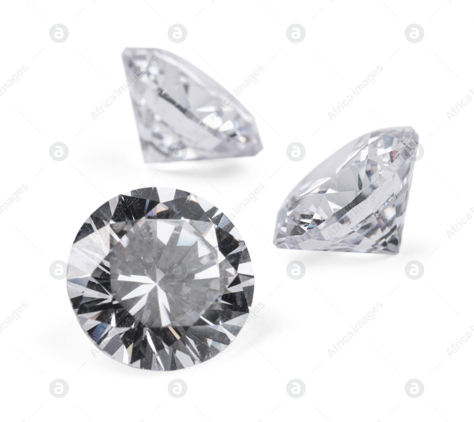 Photo of Three beautiful shiny diamonds isolated on white