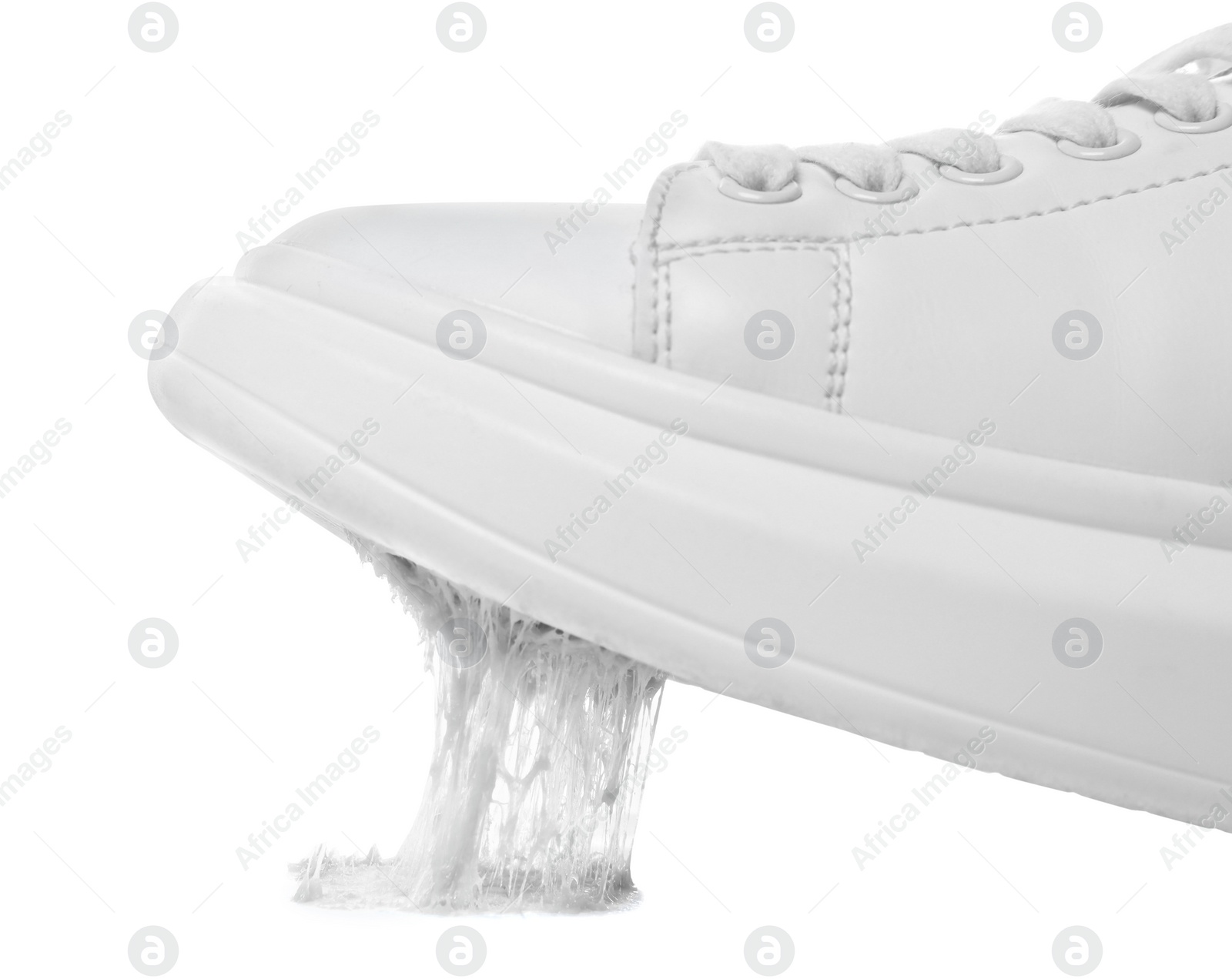 Photo of Shoe with chewing gum on sole against white background, closeup