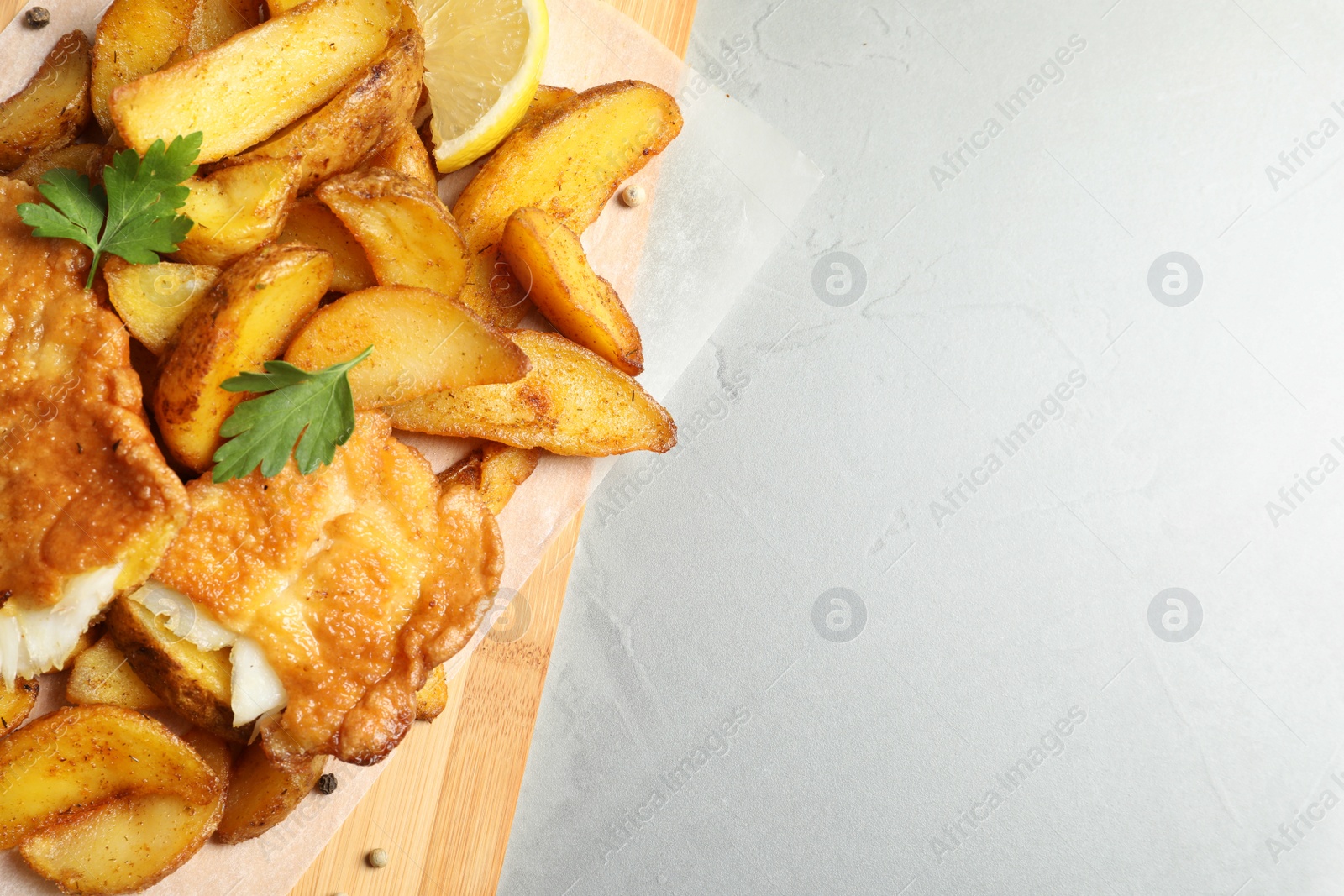 Photo of British traditional fish and potato chips on table, top view with space for text