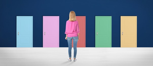 Image of Woman standing in front of many colorful doors, back view. Banner design