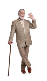 Senior man with walking cane waving on white background