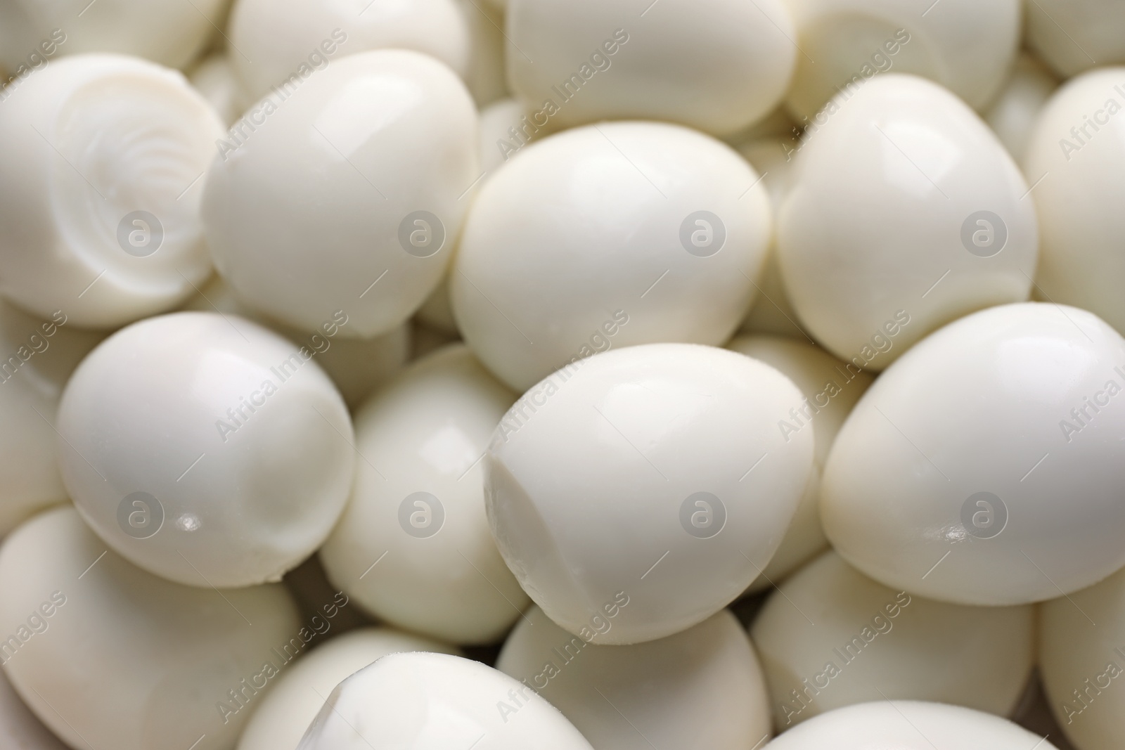 Photo of Peeled boiled quail eggs as background, closeup