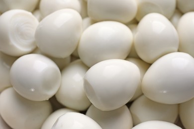 Peeled boiled quail eggs as background, closeup