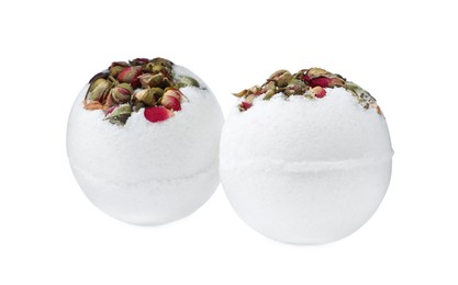 Photo of Two bath bombs with dried flowers on white background