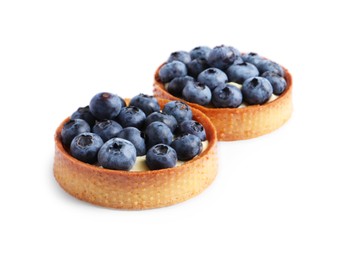 Tartlets with fresh blueberries isolated on white. Delicious dessert