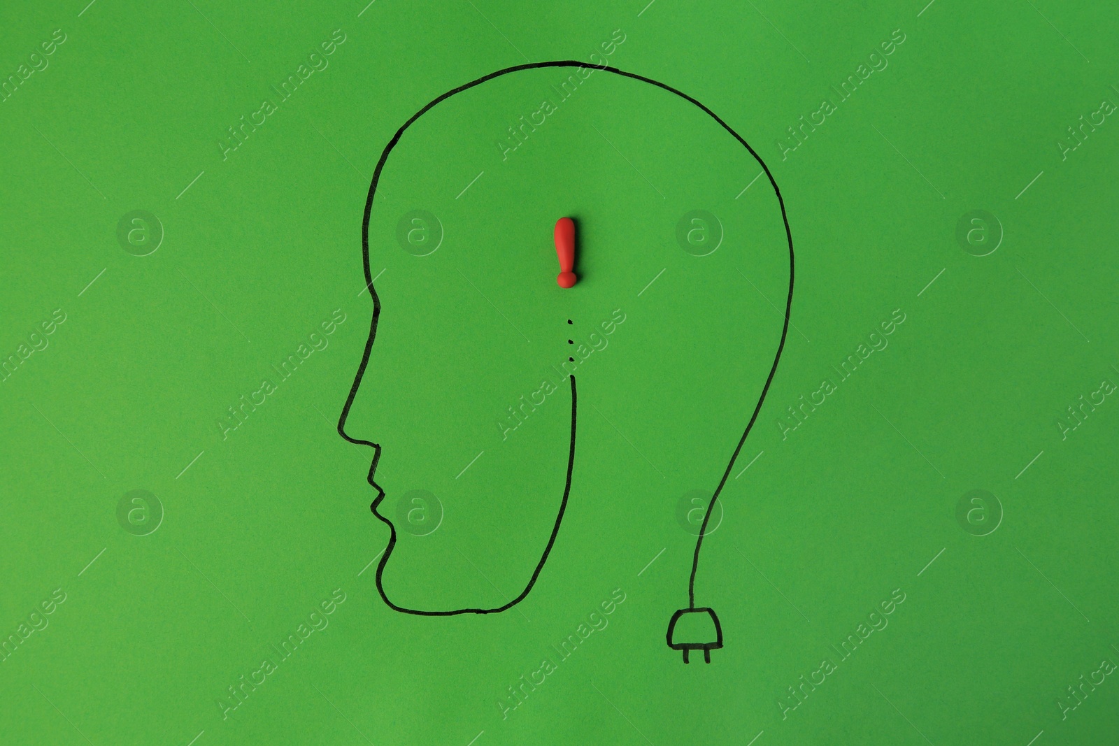 Photo of Drawn human head with red exclamation mark as solution idea on green background, top view
