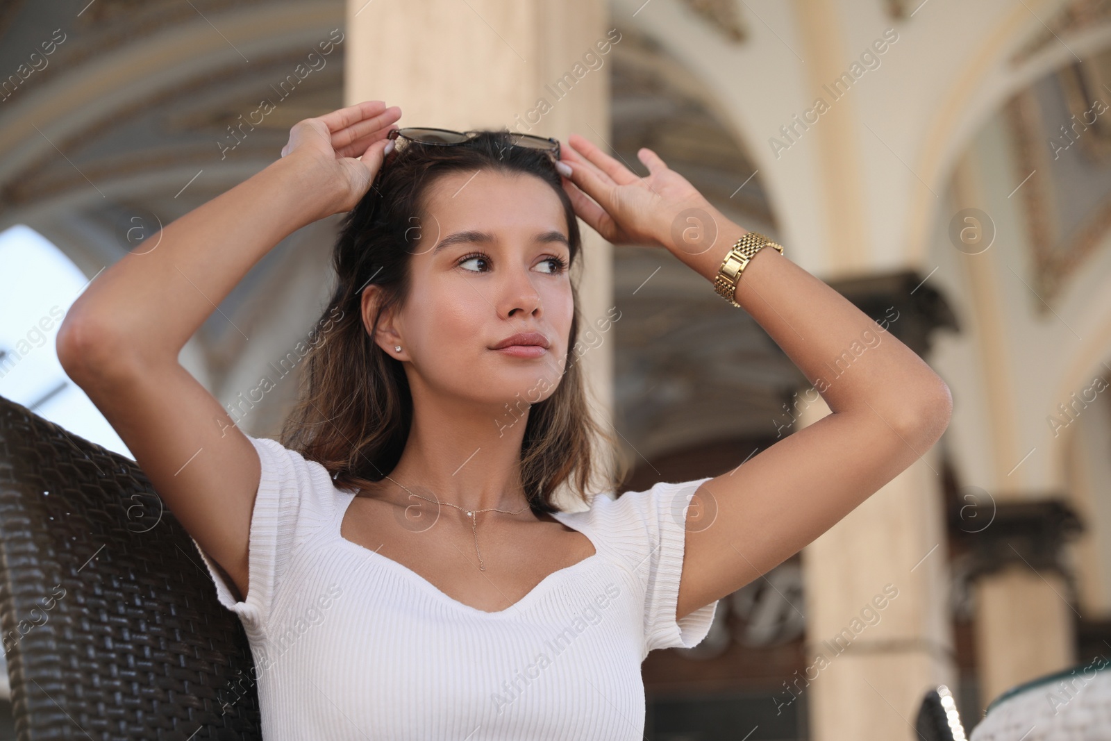 Photo of Portrait of beautiful young woman in outdoor cafe