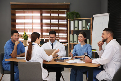 Team of professional doctors having meeting in office