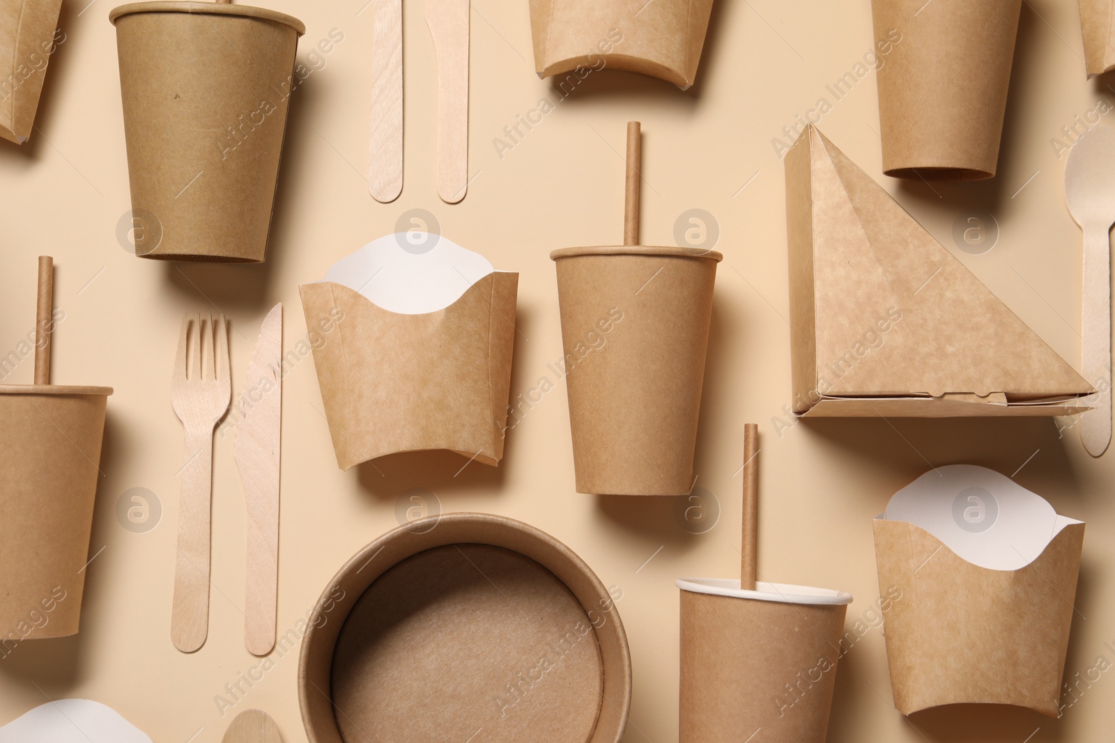 Photo of Flat lay composition with eco friendly food packagings on beige background