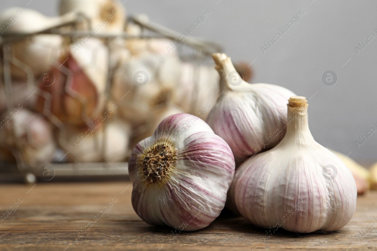 Photo of Fresh organic garlic on wooden table, closeup