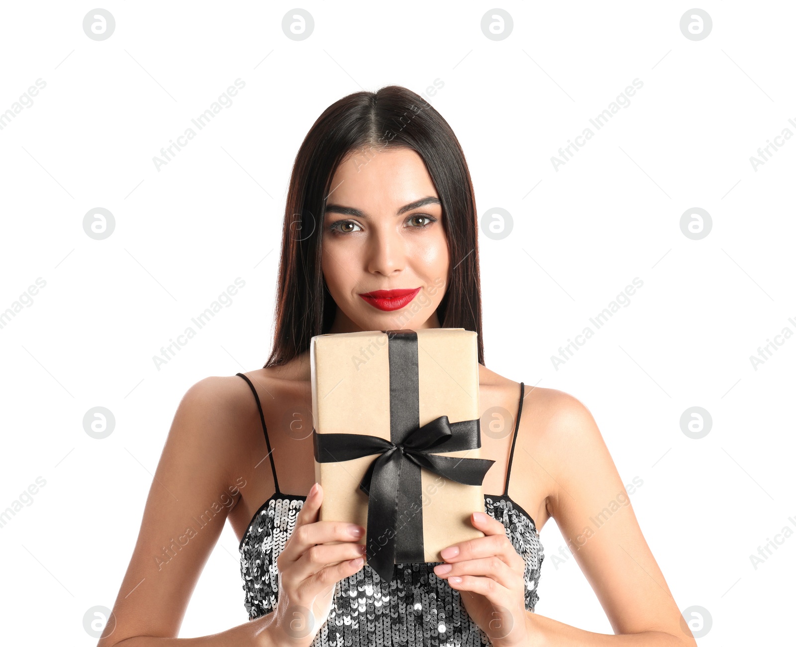 Photo of Woman in party dress holding Christmas gift on white background