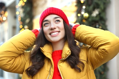 Portrait of smiling woman on city street in winter