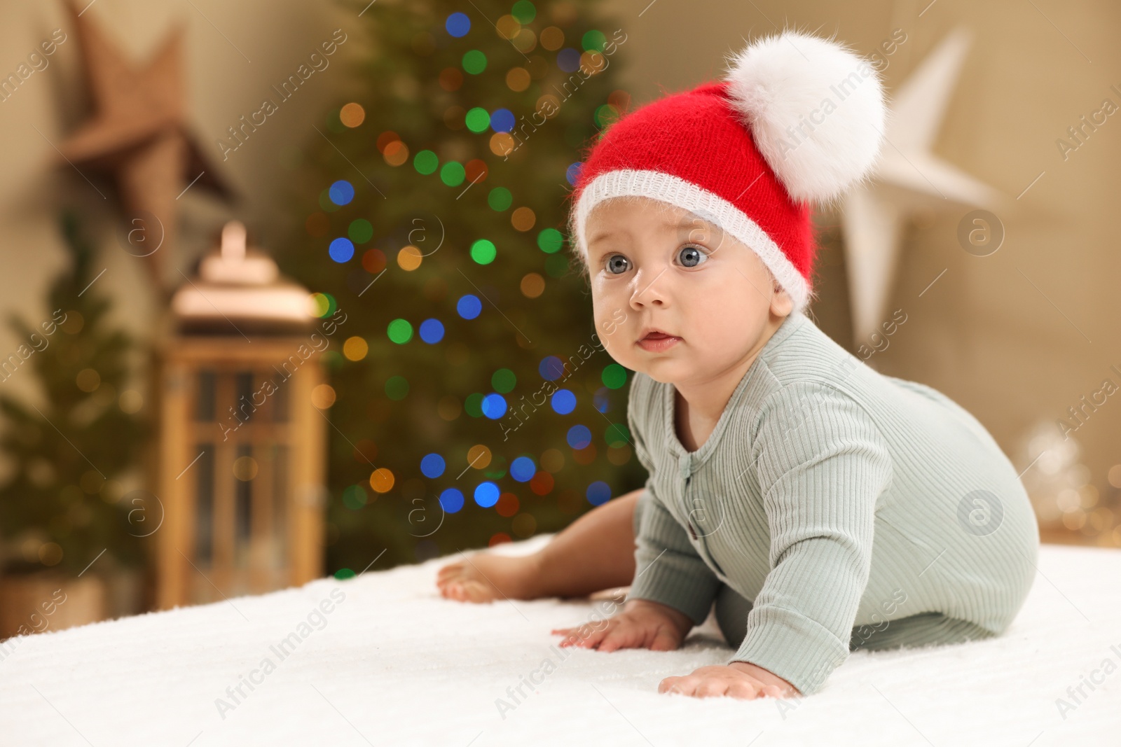 Photo of Cute little baby in room decorated for Christmas. Winter holiday