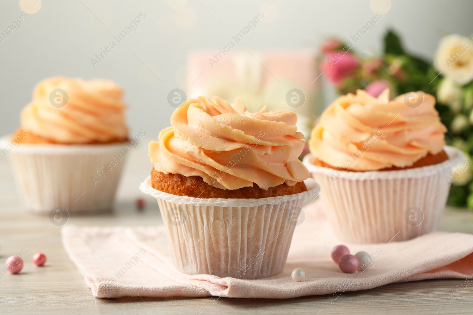 Photo of Tasty cupcakes with cream on table, closeup