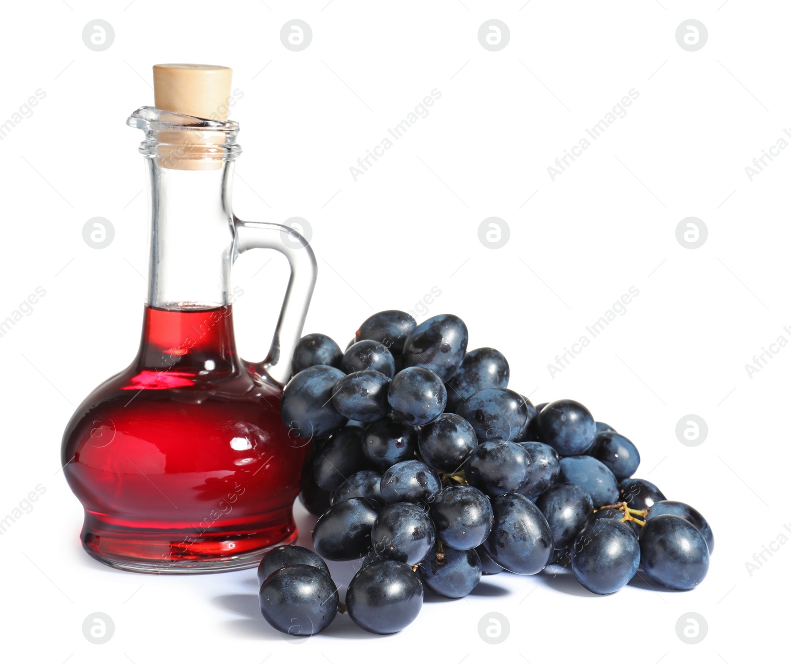 Photo of Glass jug with wine vinegar and fresh grapes on white background