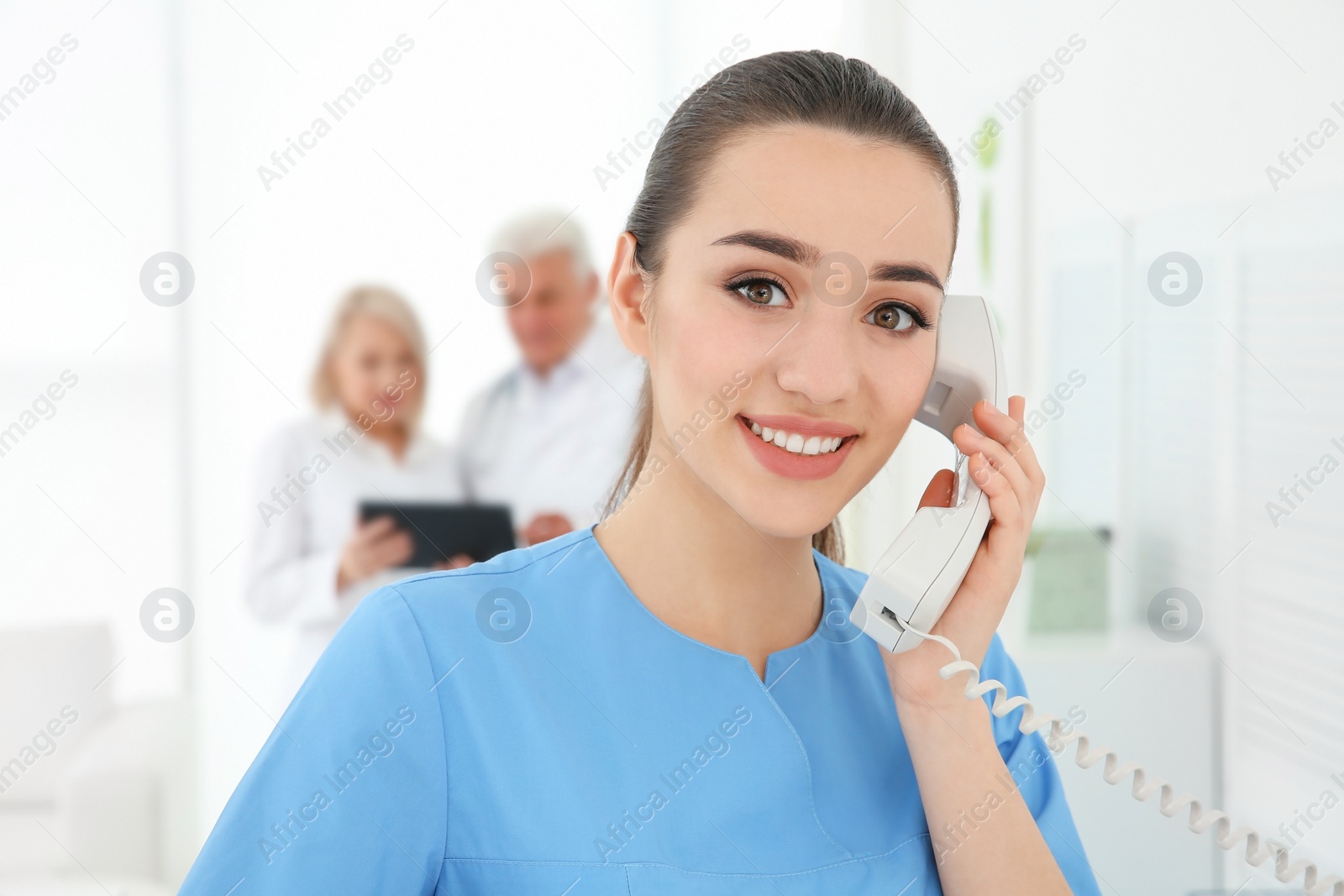Photo of Young female receptionist working in hospital