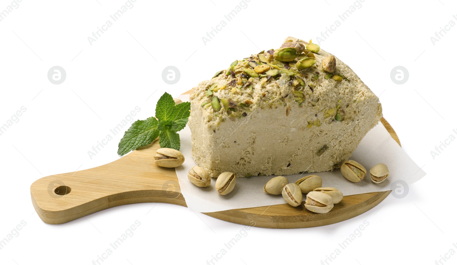 Photo of Piece of tasty halva with pistachios and mint on white background