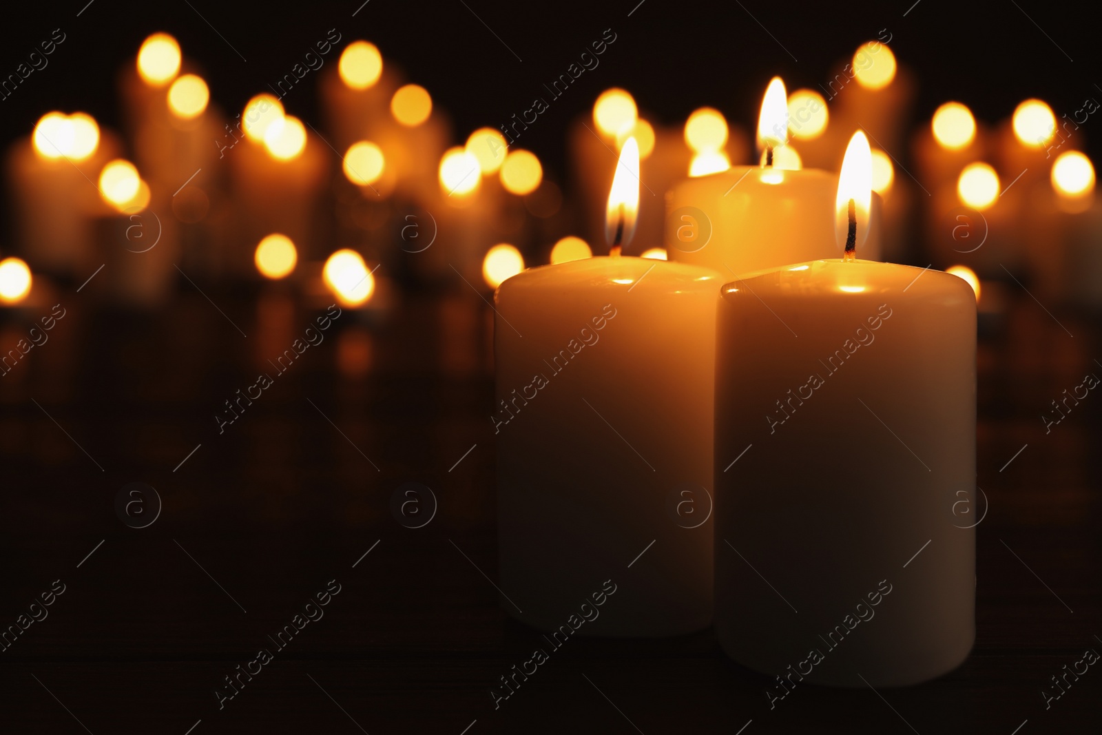 Photo of Burning candles on dark table, space for text. Memory day
