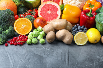 Photo of Different products rich in vitamin C on grey table