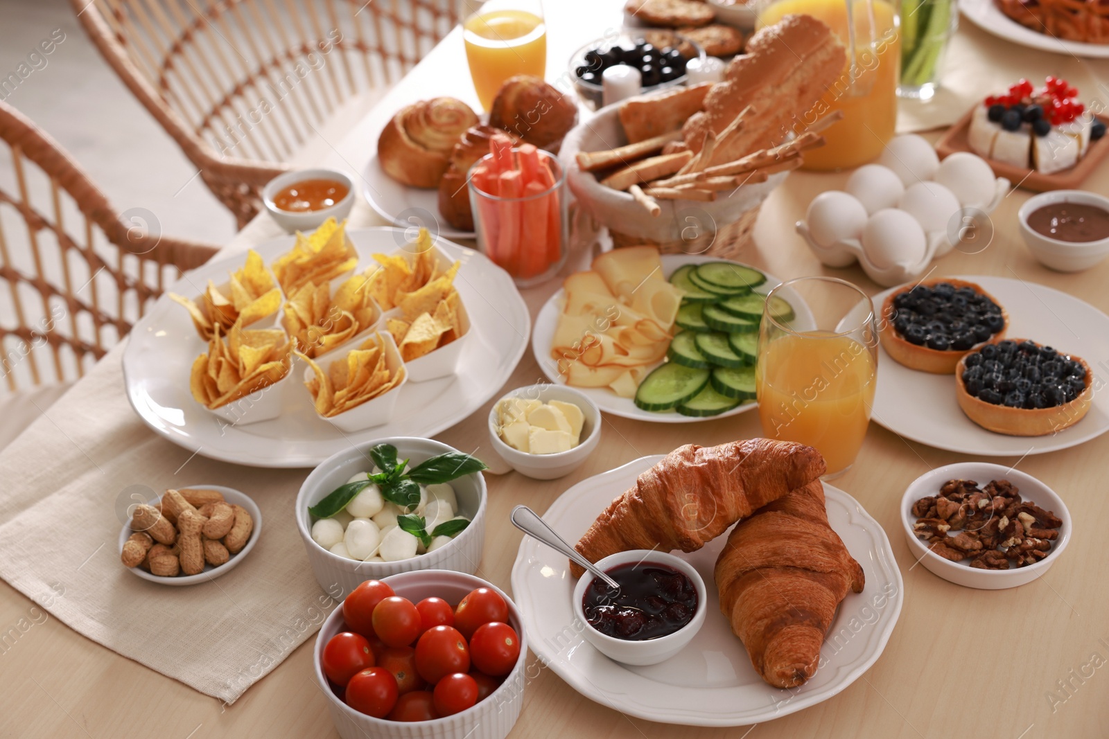 Photo of Dishes with different food on table indoors. Luxury brunch