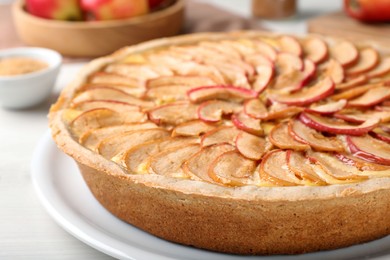 Tasty apple pie on white table, closeup