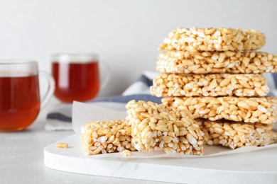 Photo of Delicious rice crispy treats on light grey table