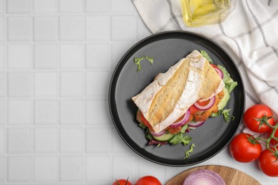Photo of Delicious sandwich with schnitzel on white tiled table, flat lay. Space for text