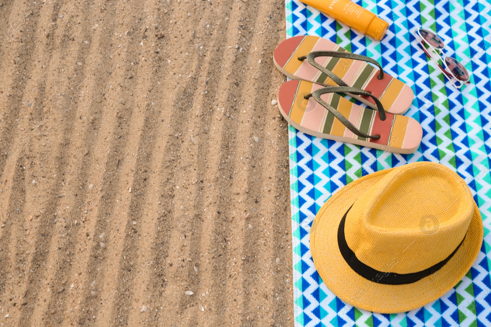 Photo of Composition with beach accessories on sand. Space for text