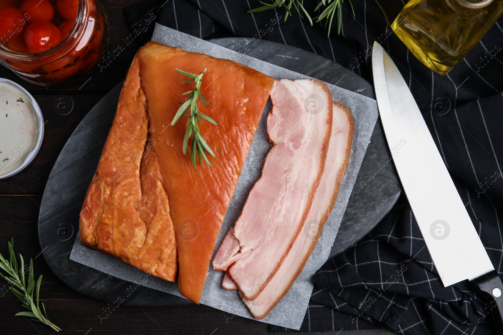 Photo of Flat lay composition with delicious smoked bacon on wooden table