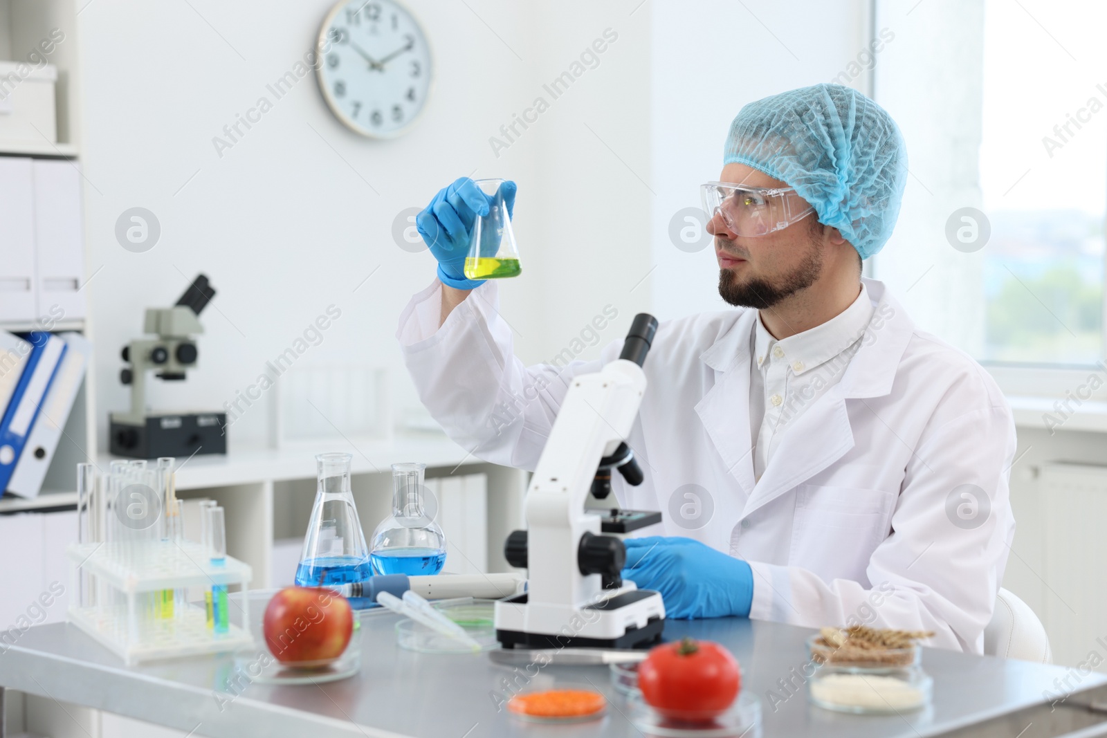 Photo of Quality control. Food inspector checking safety of products in laboratory